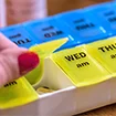 Woman opening a pill container | Working with your healthcare team