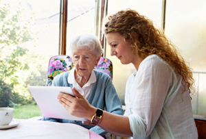 Woman surveying elderly continuing care patient