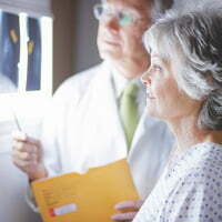 Doctor and patient reviewing x-rays | Patient safety framework