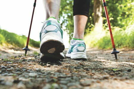 Woman walking along a trail | Alberta Health and Wellness Resources