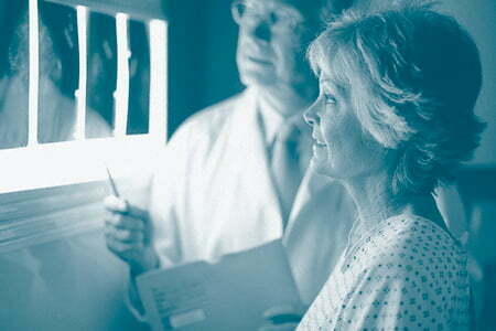 Doctor and patient reviewing x-rays | Patient safety framework