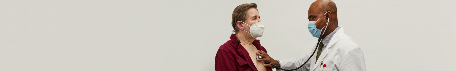 Doctor using stethoscope on patient